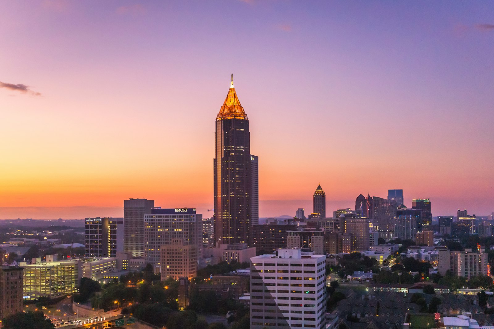 Atlanta skyline at sunset with the Bank of America Plaza spire glowing gold
